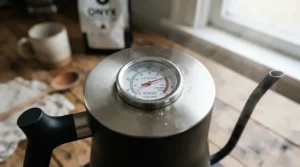 A stovetop gooseneck kettle for pour over equipped with a built-in lid thermometer for accurate water temperature.